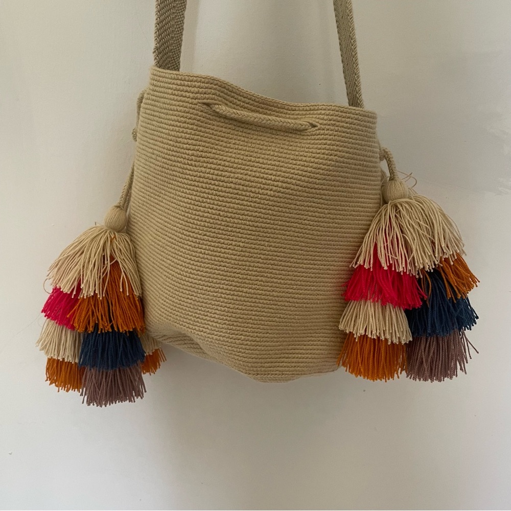 Beige Chila Bucket Bag with pink, blue, and orange tassels